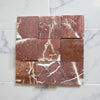Nine square Rojo Alicante 4x4 tumbled burgundy marble tiles with prominent white veining