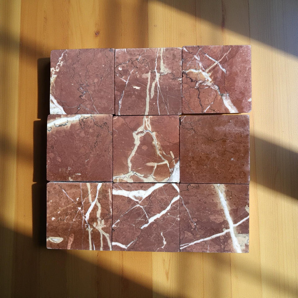 Nine square Rojo Alicante 4X4 tumbled red marble tiles with white and beige veining