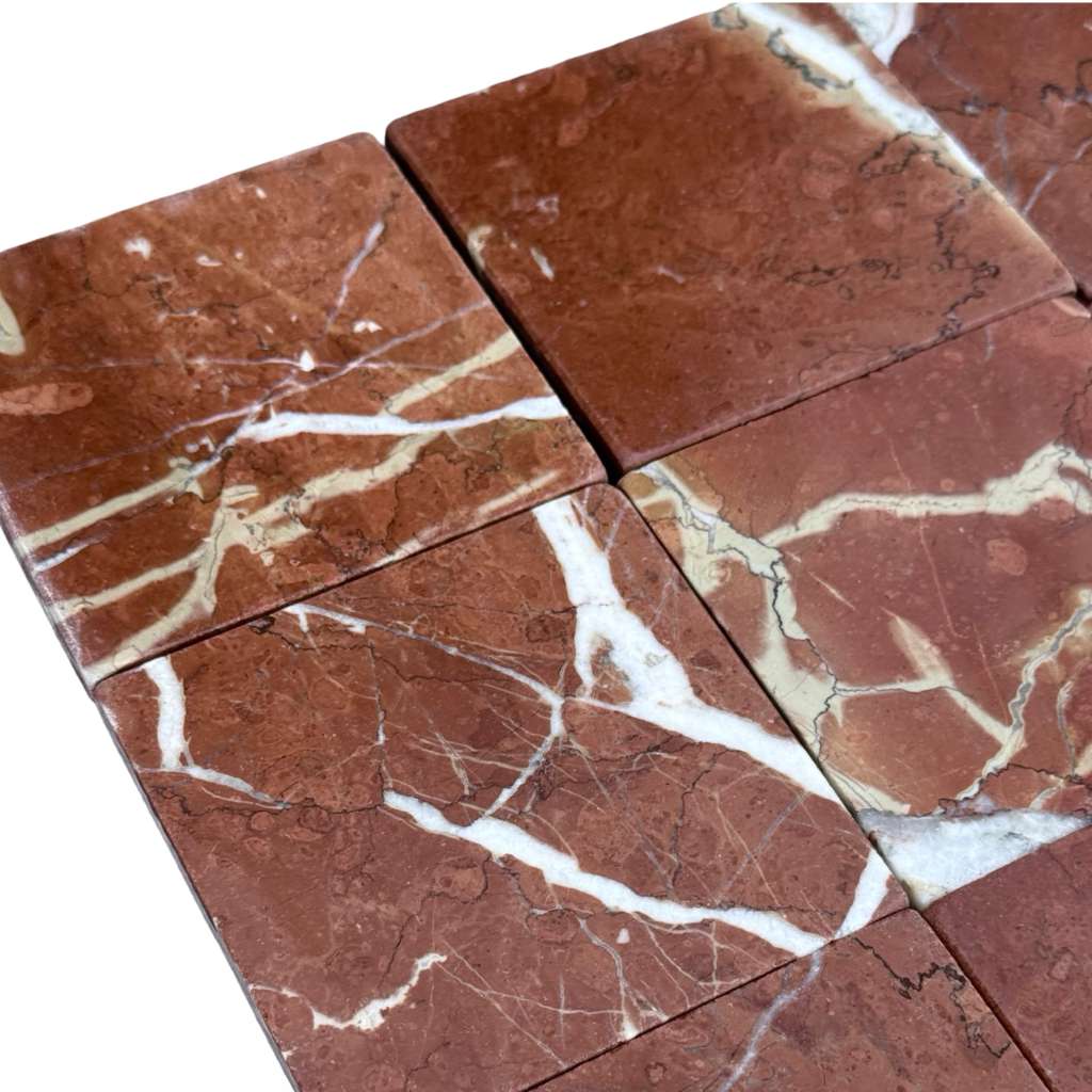 Red marble tiles with white and beige veining in Rojo Alicante 4X4 Tumbled style
