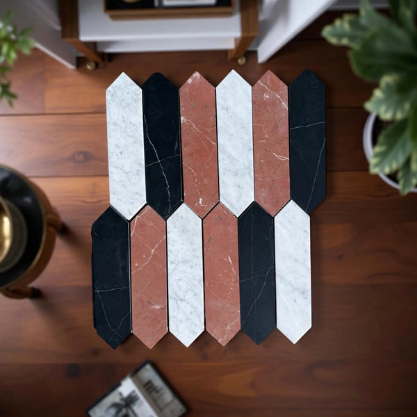 Arrow-shaped black, white, and terracotta marble mosaic tiles in Rojo Alicante design