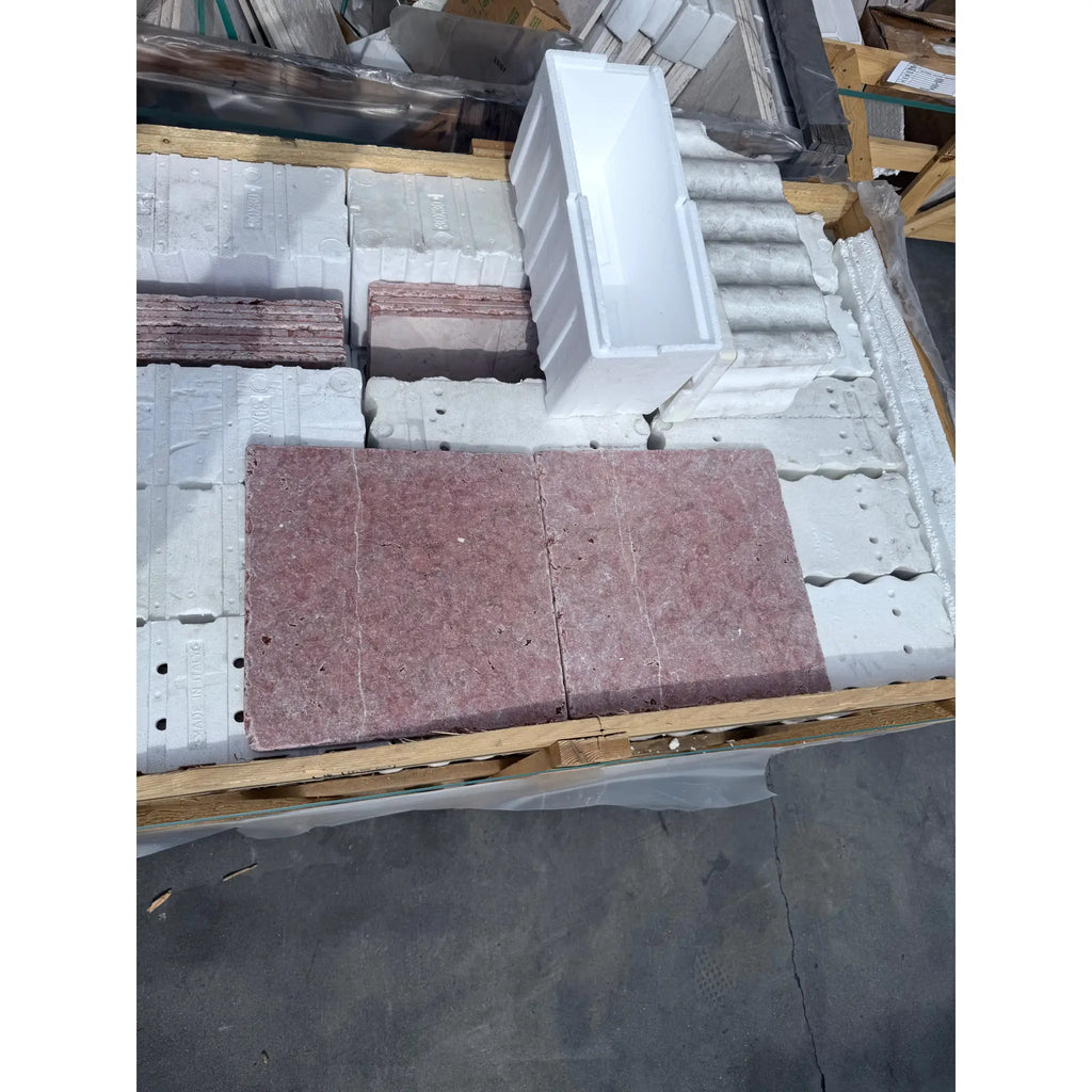 Stacked Rojo Alicante Marble 12X12 Tumbled paving stones with a white container