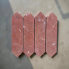 Four red marble arrow tiles from Rojo Alicante Marble 3’’ X 12’’ Picket Mosaic