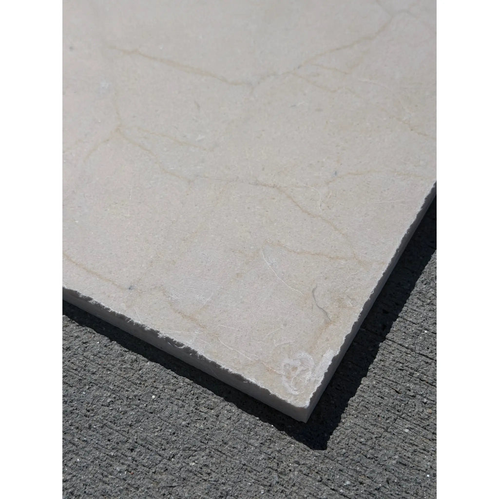 Cream-colored Rojo Alicante marble tile with subtle veining, tumbled polish