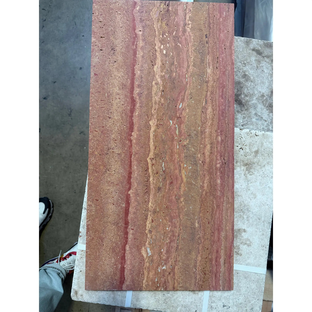 A 12x24 rectangular slab of rojo red vein-cut travertine stone with reddish-brown color and natural veining patterns polished and honed