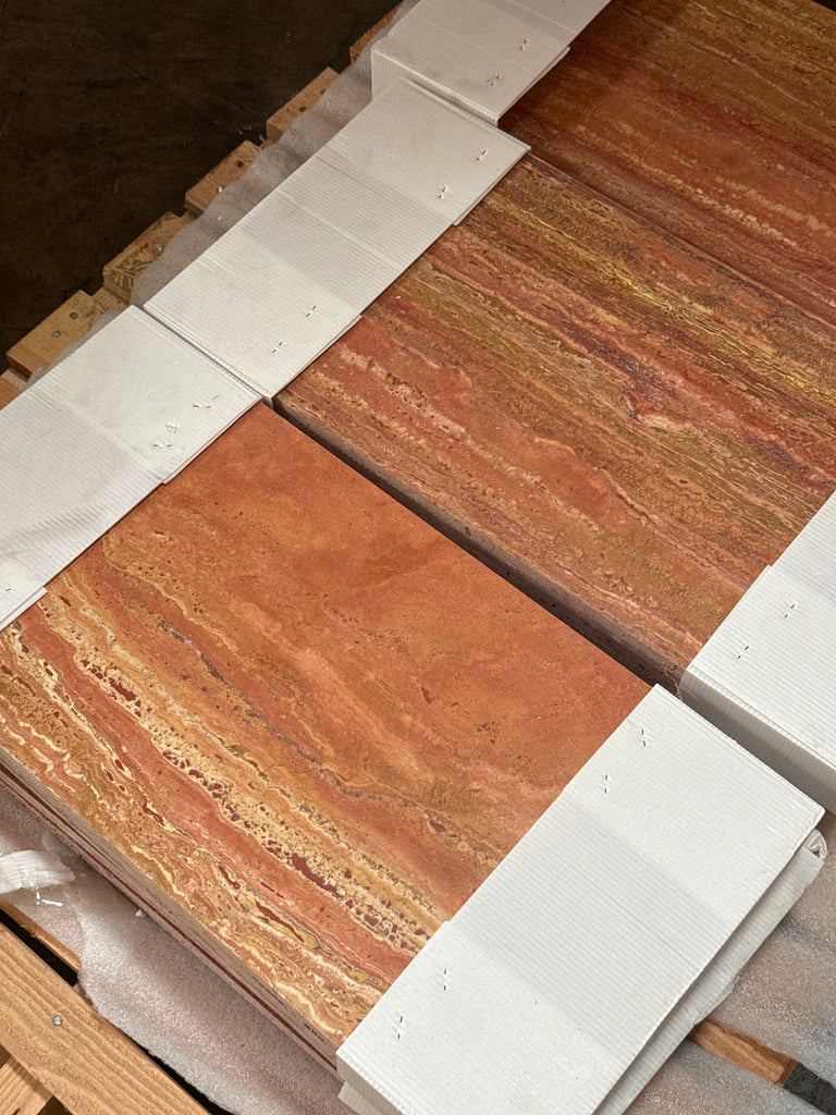 Stacked reddish-brown travertine tiles with natural veining for Rojo Red Vein-Cut Travertine