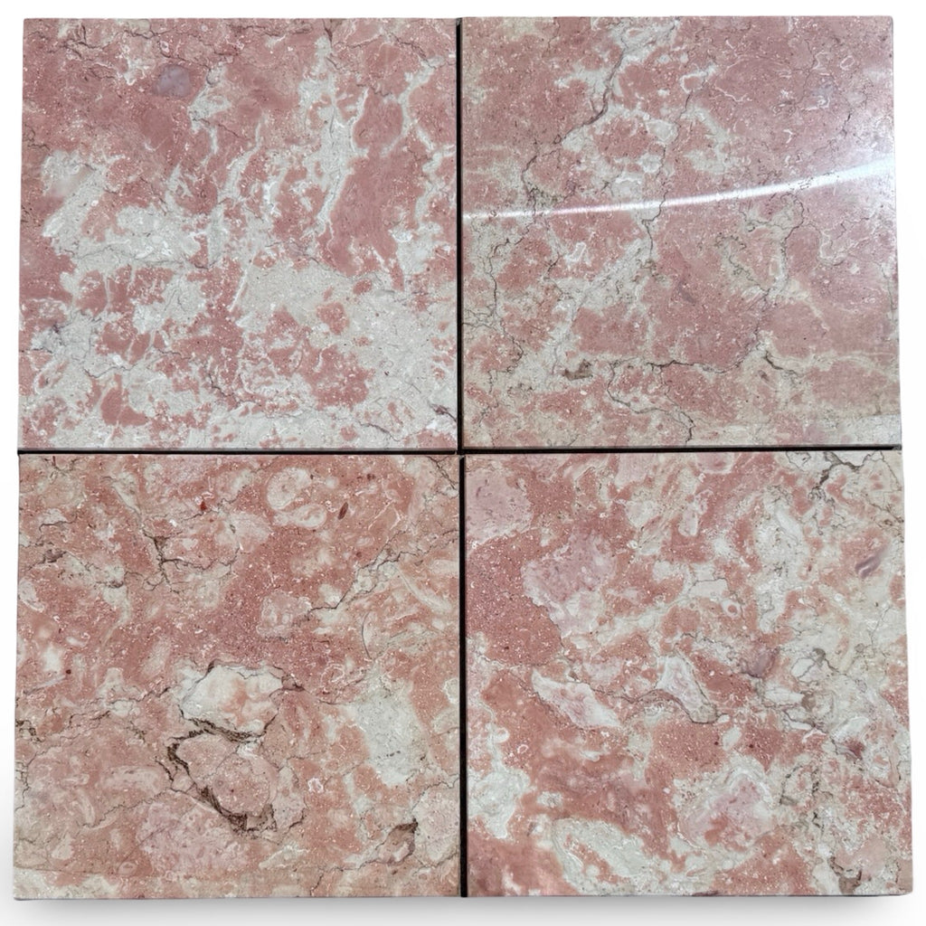 Four polished Rosé Aurora Marble 12x12 tiles with pinkish-red base and veining