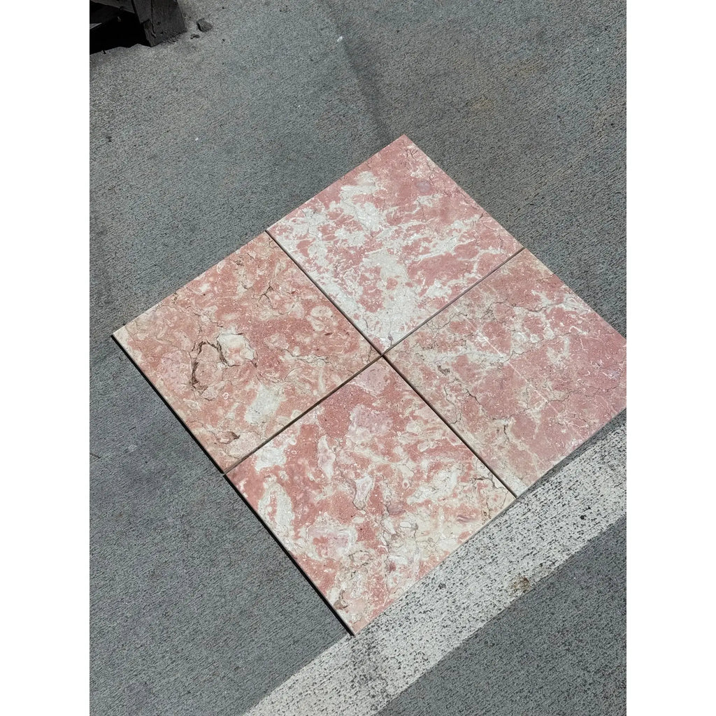 Four pink and white marbled tiles from Rosé Aurora Marble 12X12 Polished collection