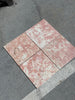 Four pink and white marbled tiles from Rosé Aurora Marble 12X12 Polished collection