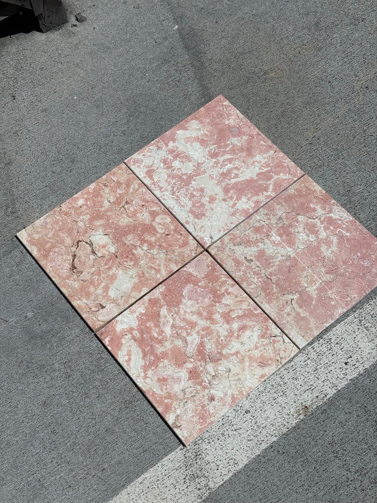 Four pink and white marbled tiles from Rosé Aurora Marble 12X12 Polished collection