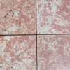 Four pink and white Rosé Aurora Marble 12x12 polished tiles with natural veining and cracks