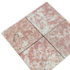 Four pink and white variegated marble tiles from Rosé Aurora Marble 12X12 Polished