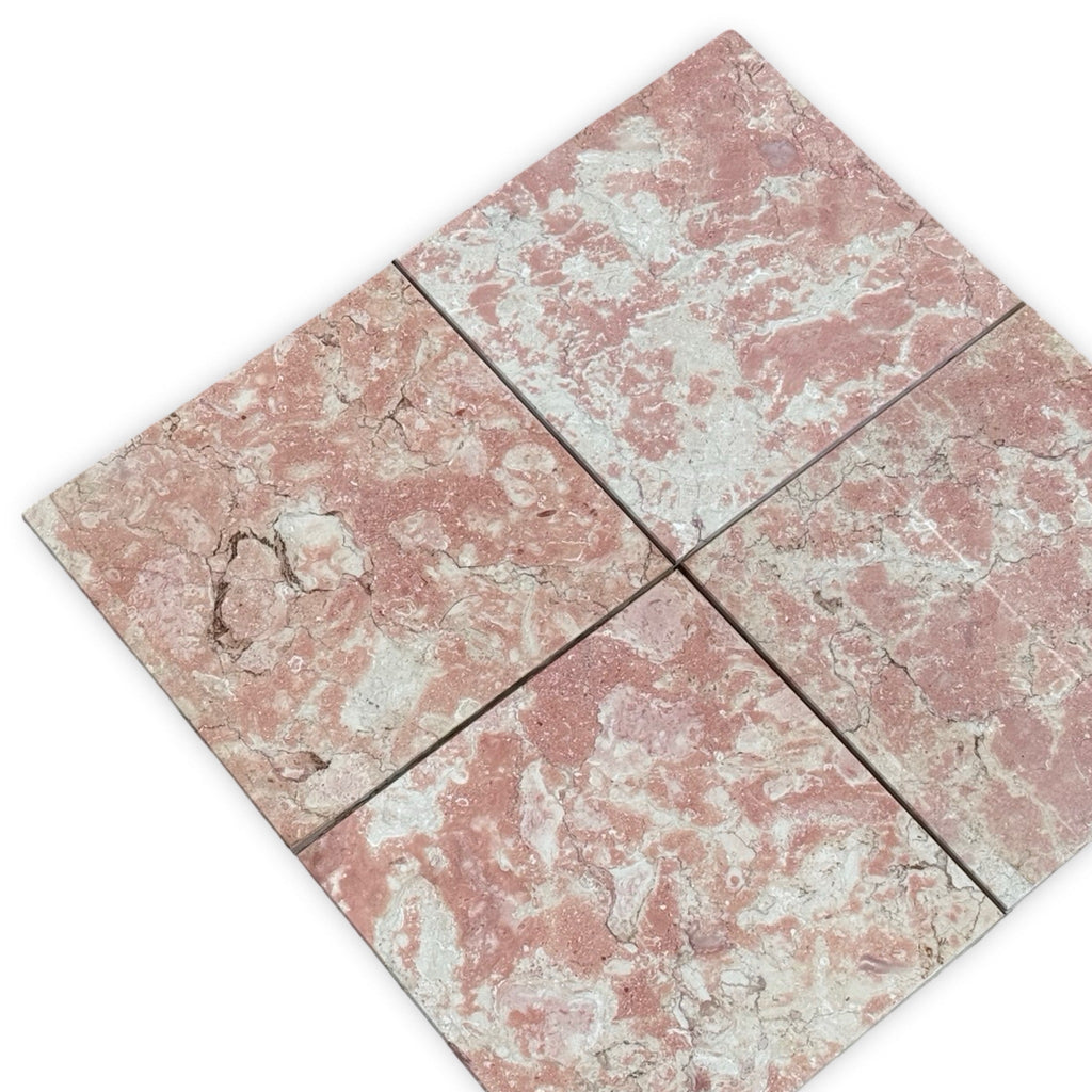 Four pink and white variegated marble tiles from Rosé Aurora Marble 12X12 Polished