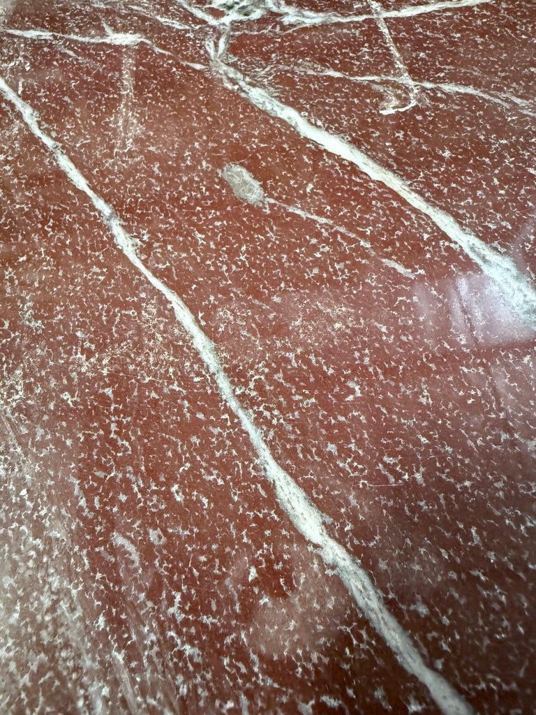 Highly polished Rosso Laguna Marble surface with white and grey veining