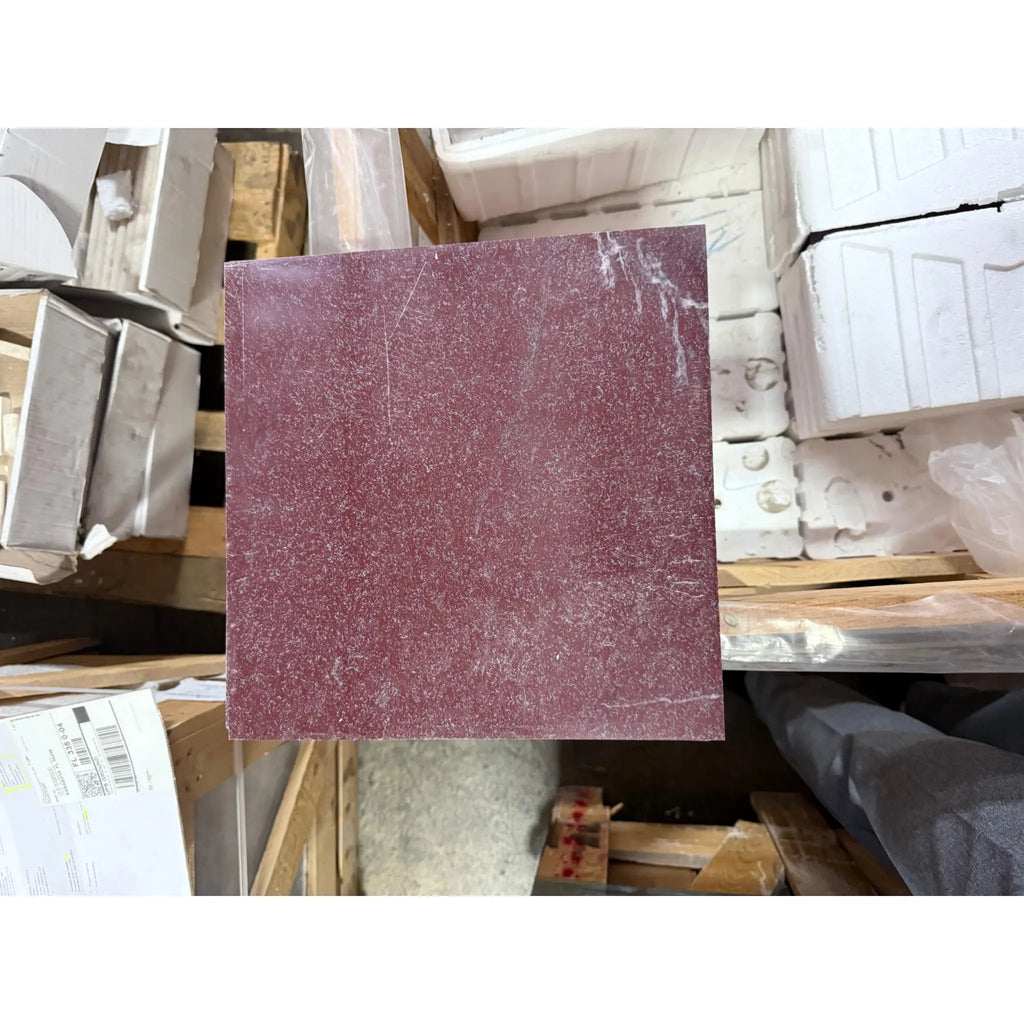 Maroon sandpaper sheet with coarse texture and white scuff marks for Rosso Laguna Marble