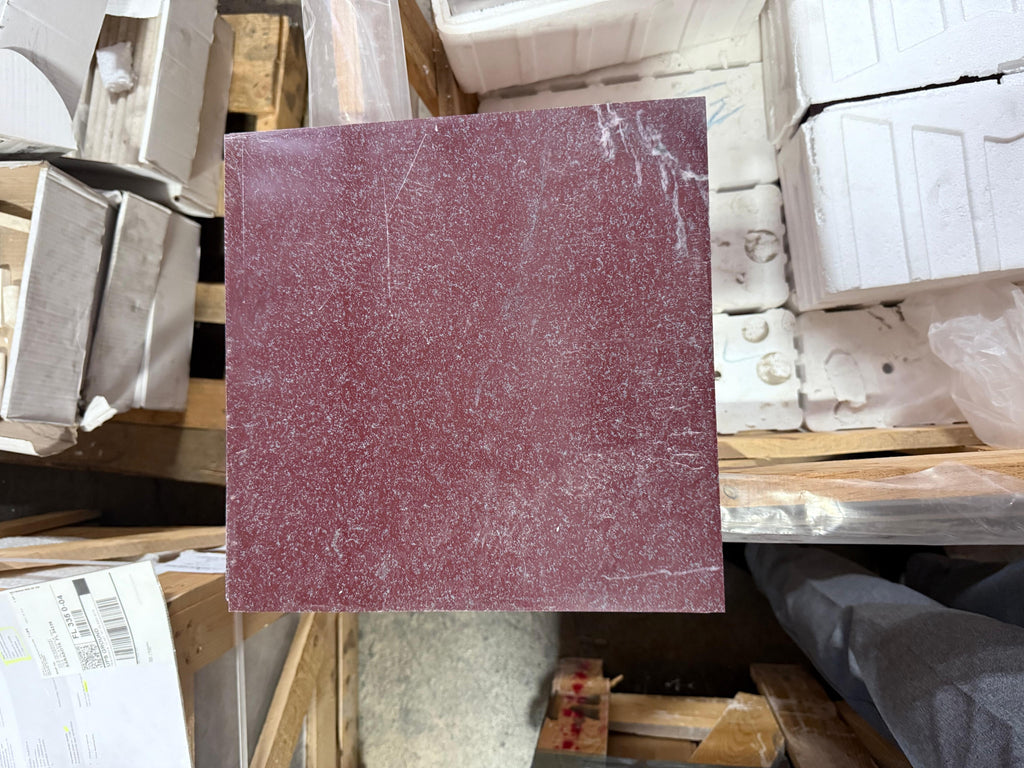Maroon sandpaper sheet with coarse texture and white scuff marks for Rosso Laguna Marble