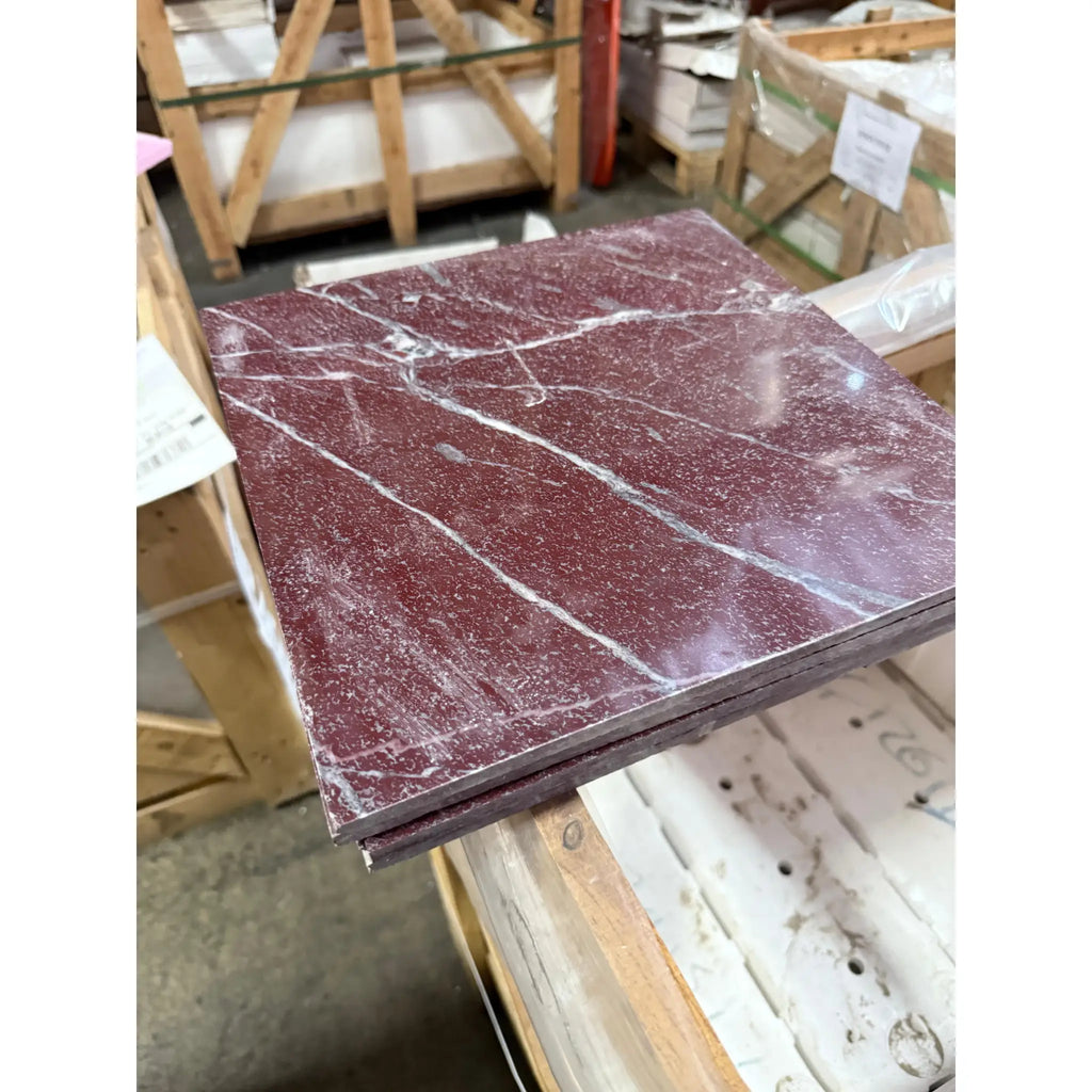 Polished Dark Red Rosso Laguna Marble tiles with white veins stacked neatly