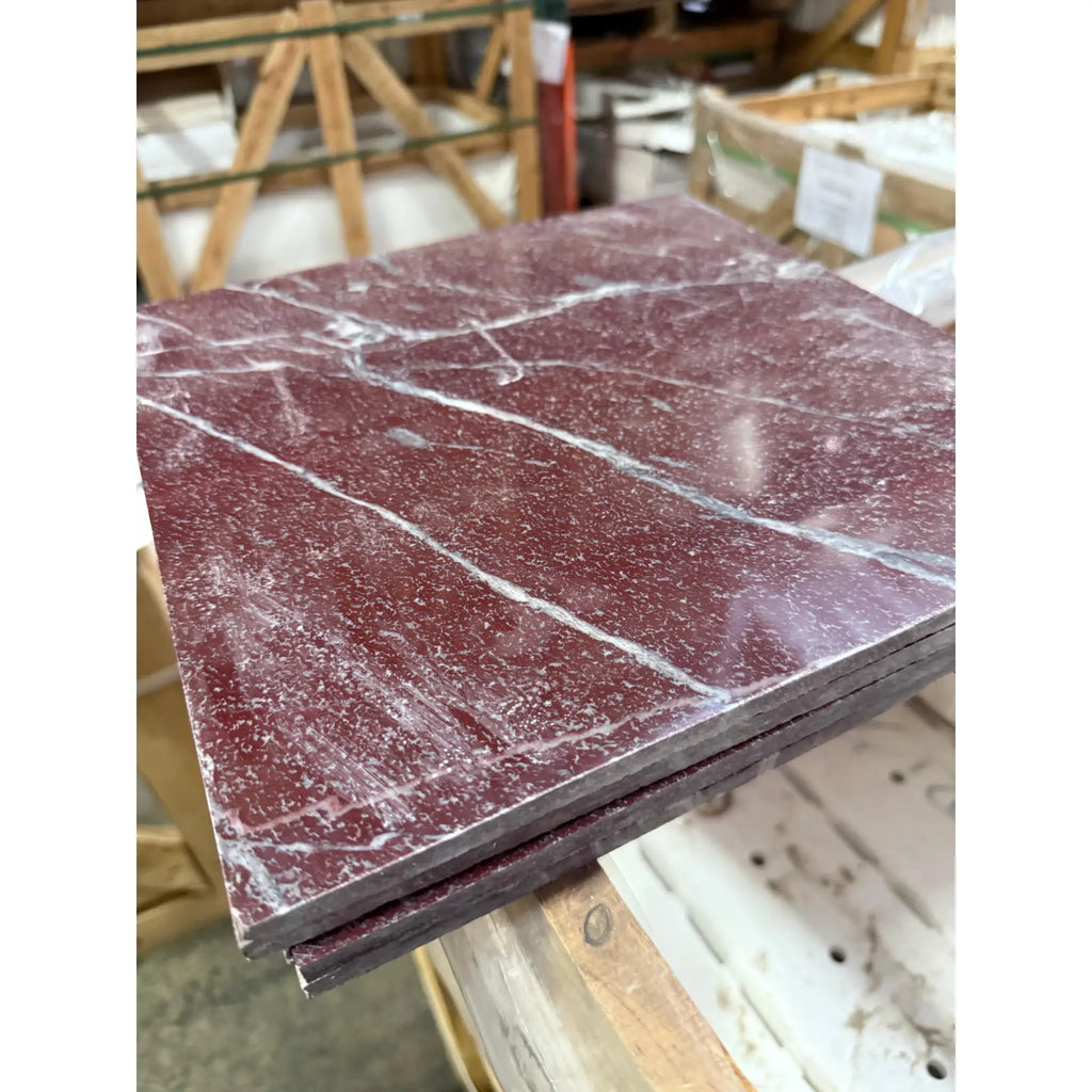 Stack of polished rectangular Rosso Laguna Marble tiles with white veining