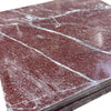 Stacked polished rectangular Rosso Laguna Marble tiles with white veining on a deep red background