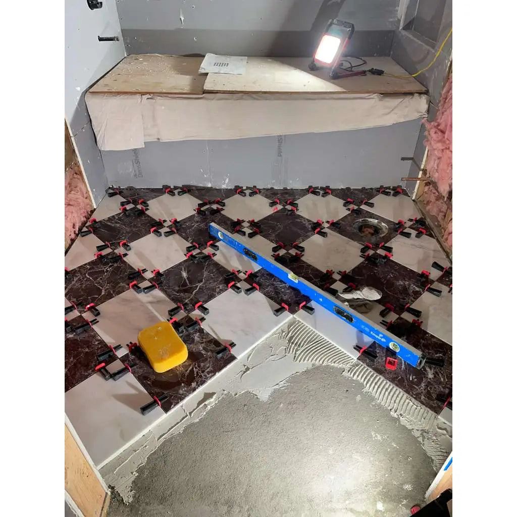 Blue level tool on Rosso Levanto marble 12x12 polished tiles