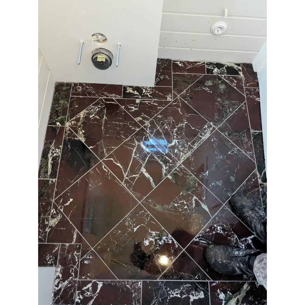 Shiny dark brown rosso levanto breccia vino marble tiles with white veining arranged in a diagonal 12x12 polished pattern