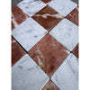 Square tiles of white and reddish brown rosso levanto breccia vino marble arranged in a polished 12x12 checkered pattern