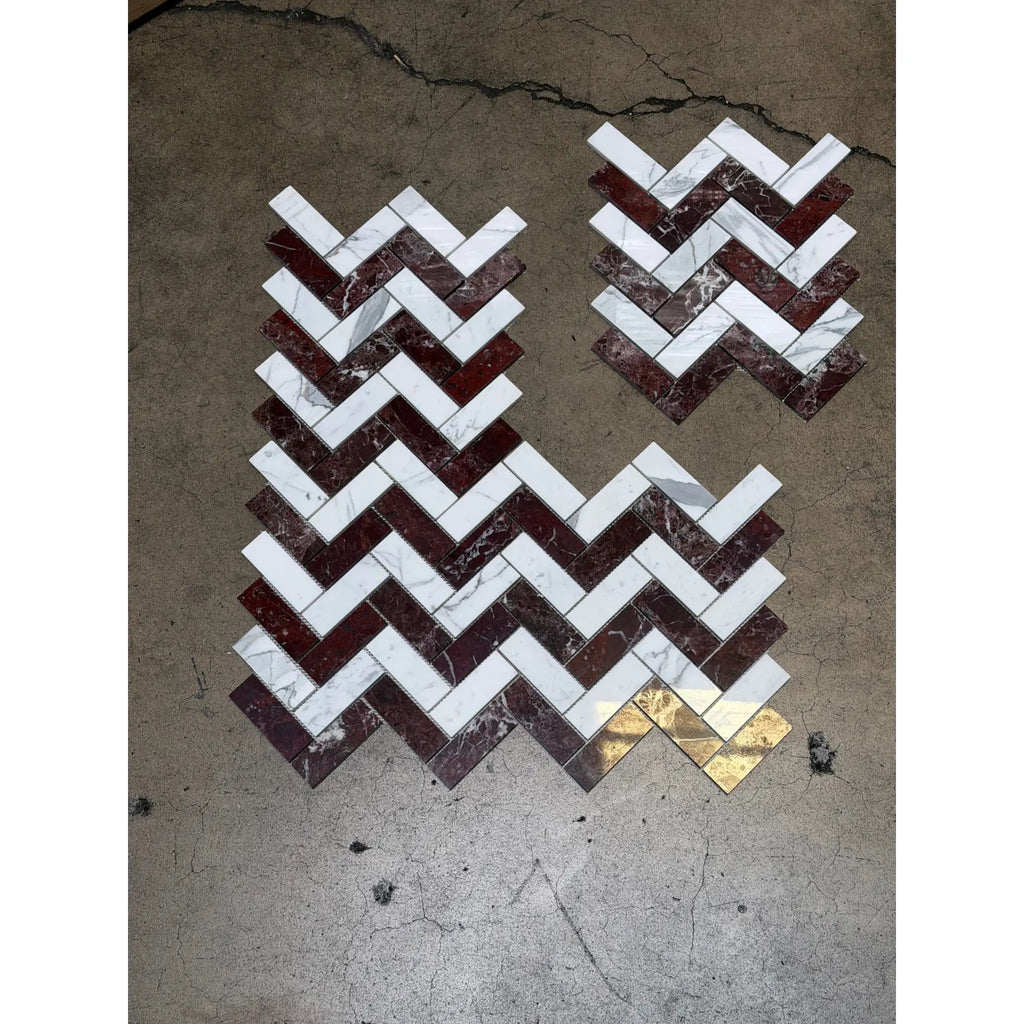 Herringbone mosaic marble tile set with rosso levanto and italian statuary rectangles featuring gold accent piece