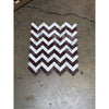 A chevron-patterned herringbone mosaic marble tile panel featuring alternating rosso levanto and italian statuary colors