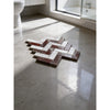 A herringbone mosaic marble floor in white italian statuary and deep red rosso levanto polished-honed tiles