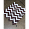A herringbone mosaic tile design featuring polished honed Rosso Levanto and Italian Statuary marble in white and deep burgundy