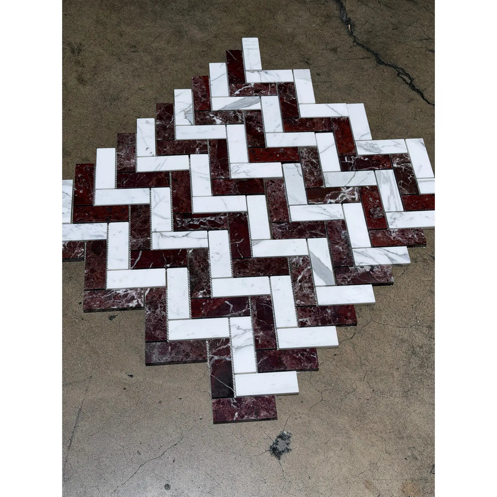 A herringbone mosaic tile design featuring polished honed Rosso Levanto and Italian Statuary marble in white and deep burgundy