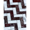 A herringbone mosaic marble tile panel featuring polished-honed rosso levanto and italian statuary in deep red and white