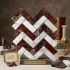 A herringbone mosaic tile display featuring alternating white and deep red Rosso Levanto and Italian Statuary marble slabs