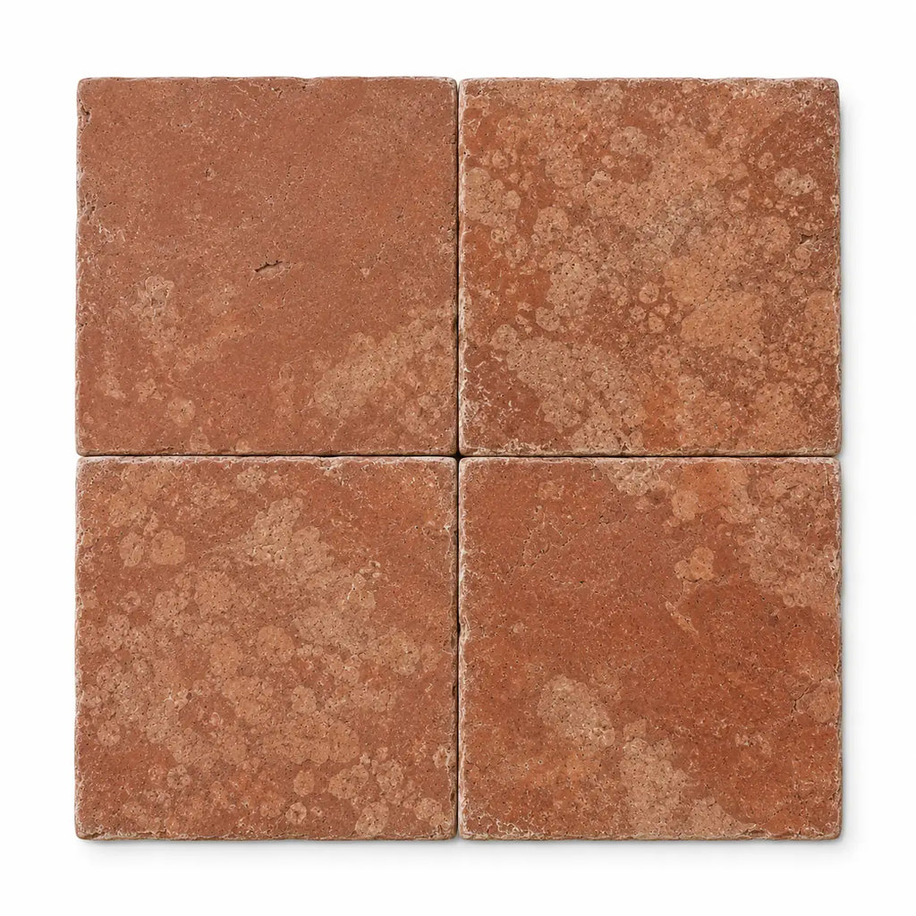 Four square 12x12 rosso verona marble tiles with rustic tumbled texture and warm reddish-brown tones
