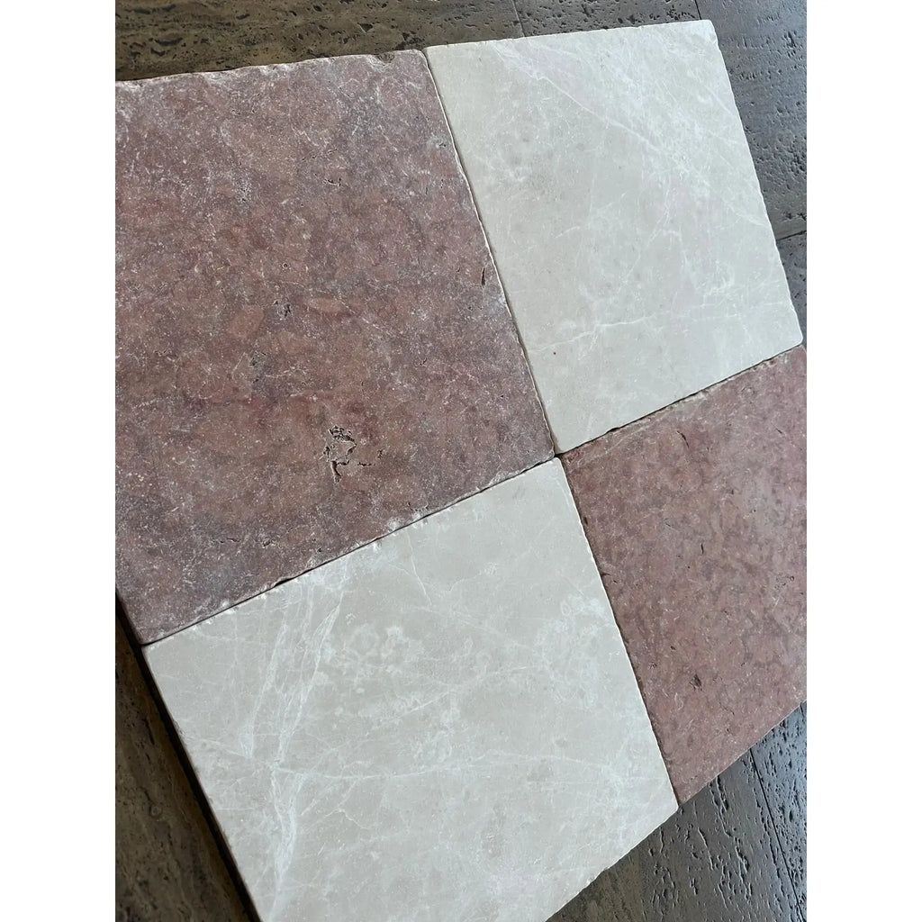 Four 12x12 tumbled rosso verona marble tiles in checkerboard with reddish-brown and creamy off-white hues and veining