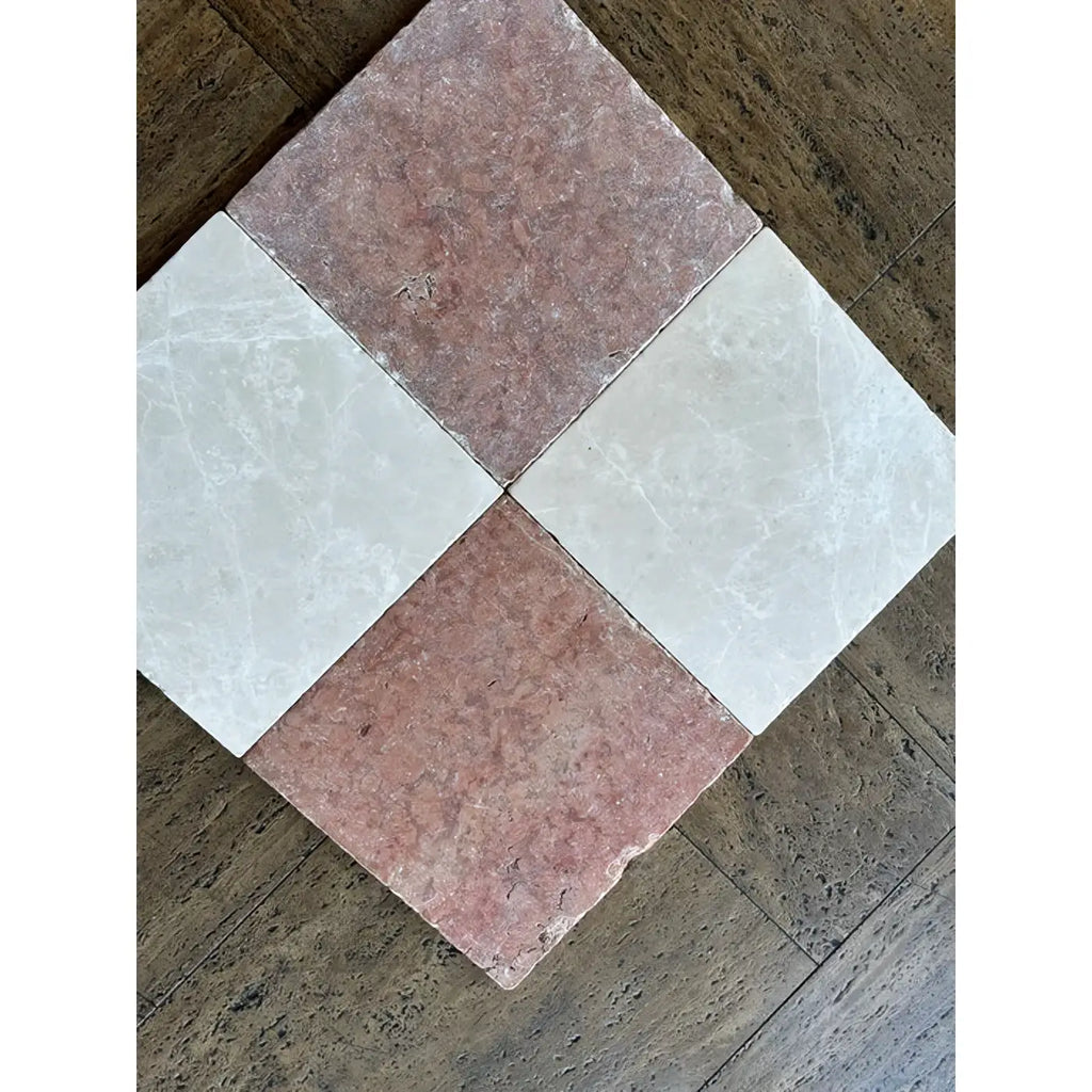 Four rosso verona marble 12x12 tumbled tiles in a diamond pattern with pink and white veined surfaces