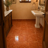 Rosso Verona marble 12x12 tumbled terracotta tiles with a polished surface installed on a bathroom floor