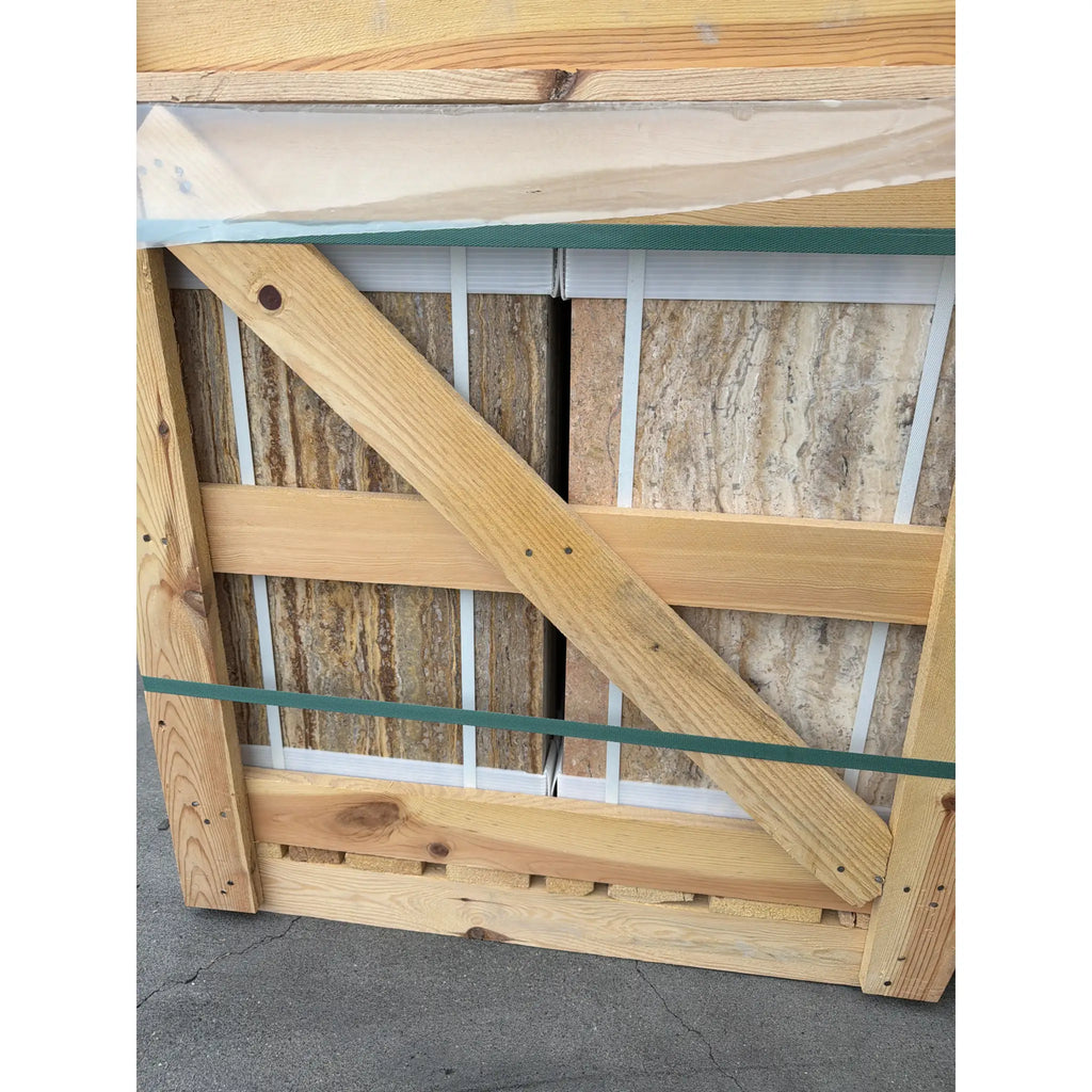 Scabos Autumn Leaves Travertine 12x24 slabs in light wood crate with green straps