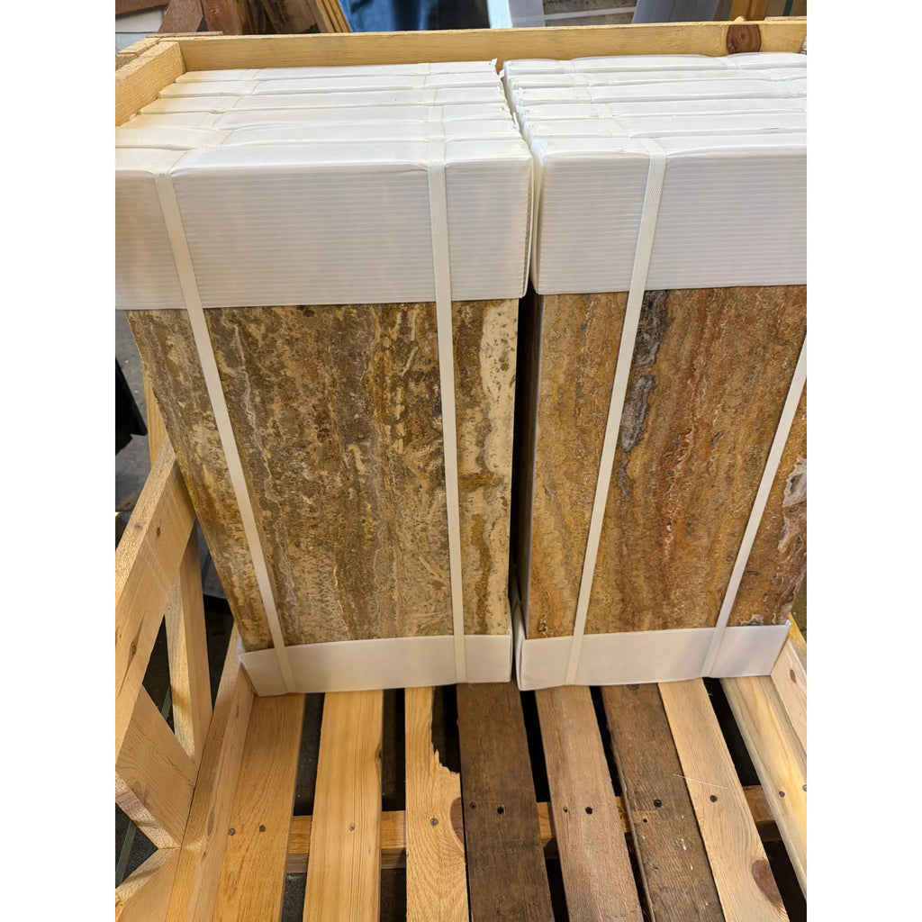 Scabos Autumn Leaves Travertine 12x24 vein-cut filled polished tiles, stacked beige gold veined stone wrapped in white protective material