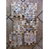 Textured natural stone mosaic tiles in beige, brown, and grey arranged vertically