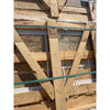 Light brown wooden structural beam with visible grain and knots secured by green straps in autumn leaves travertine set