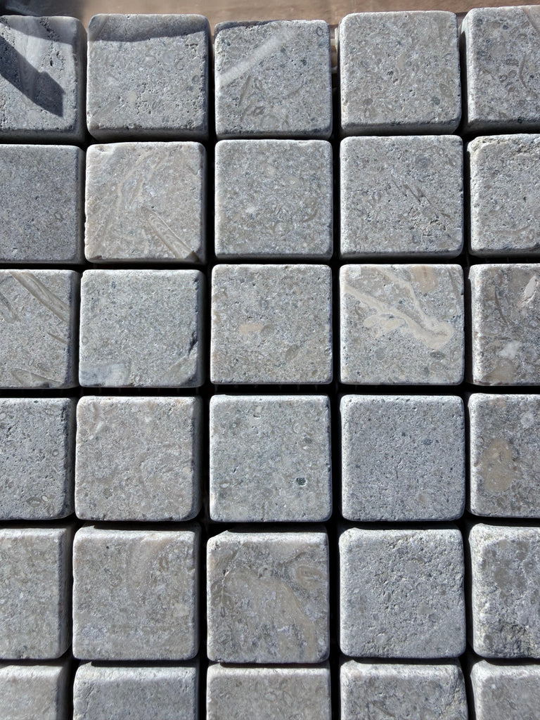 Seagrass Limestone 1x1 Mosaic Tumbled: gray stone pavers with textured veining