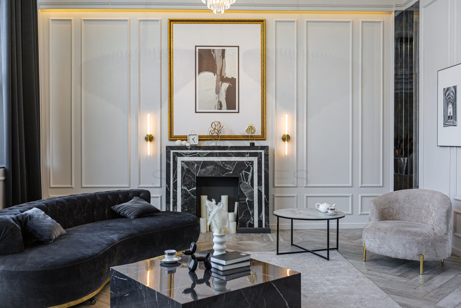 Elegant living room with a black marble fireplace, modern decor, plush seating, and contemporary artwork on the walls.