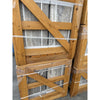 Stacked wooden crates with gray travertine slabs secured by plastic straps