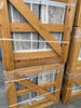 Stacked wooden crates with gray travertine slabs secured by plastic straps