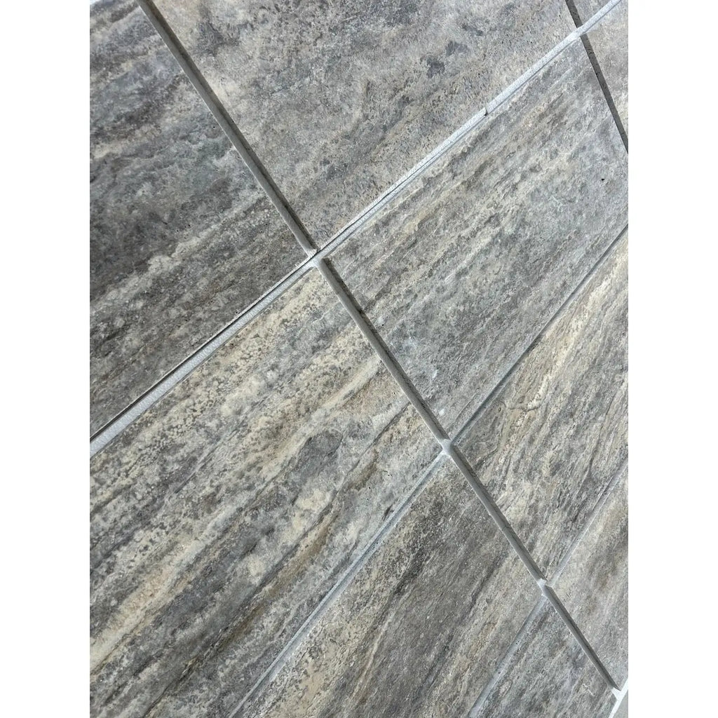 Silver gray travertine 12x24 vein-cut tile with gray stone-effect, natural textured surface, and subtle veining