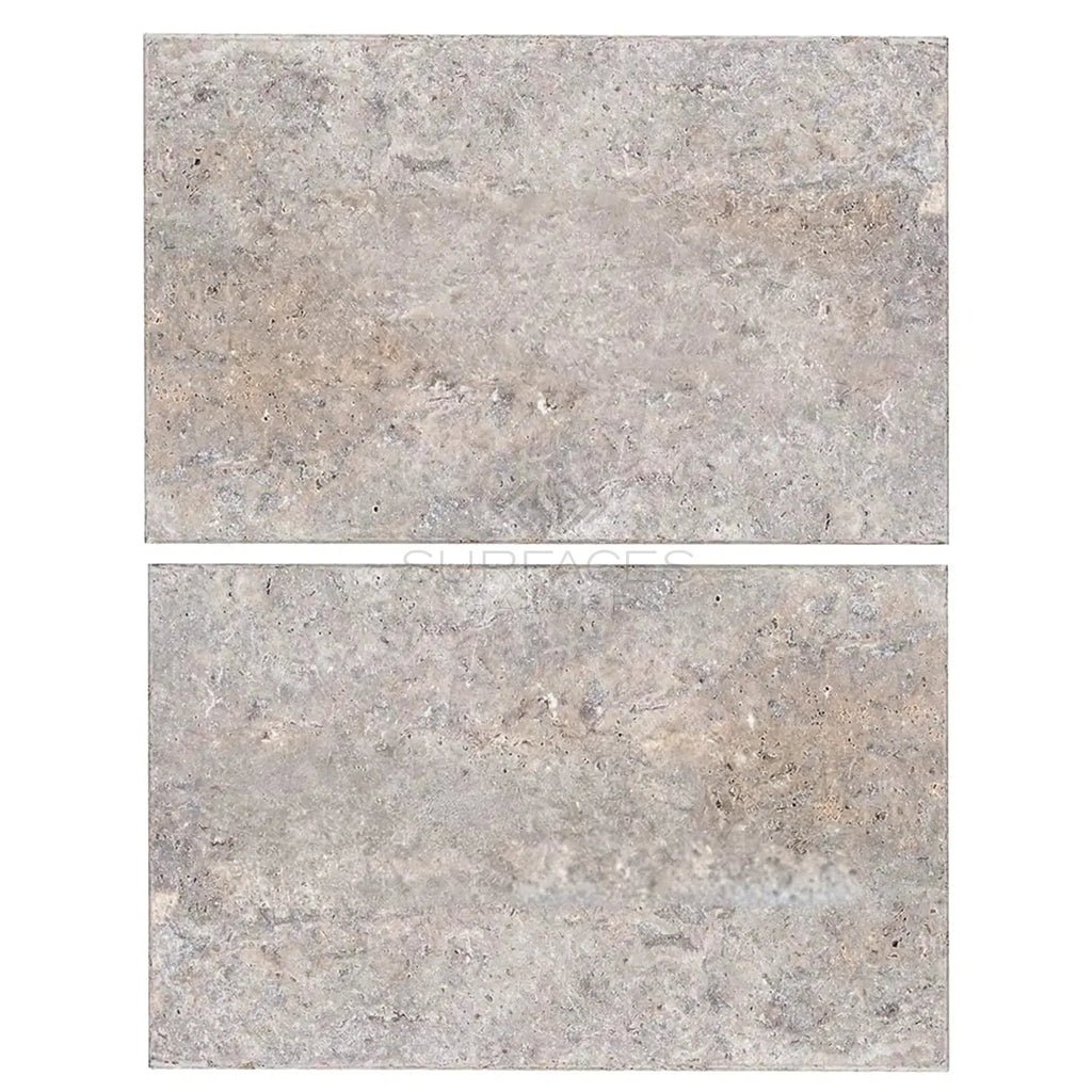 Two gray travertine tiles from the Silver (Gray) Travertine 16X24 collection