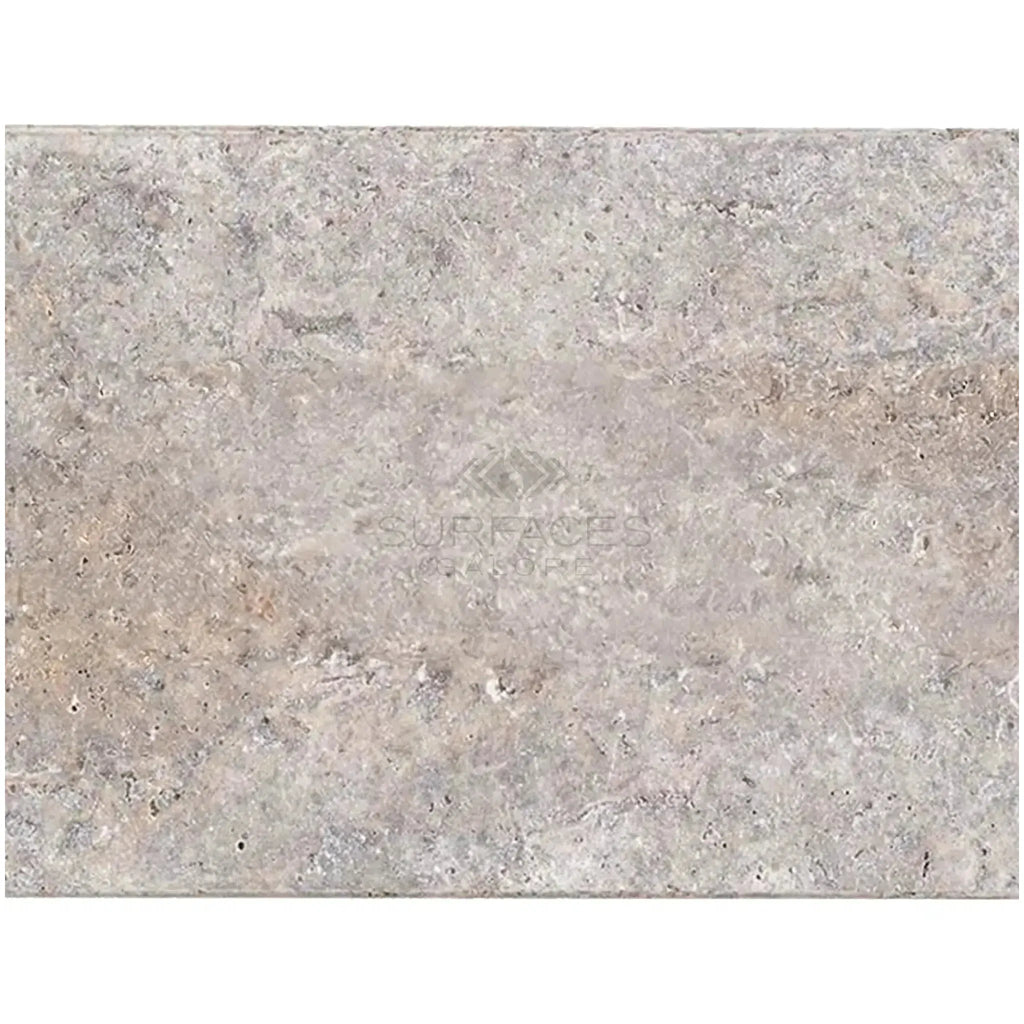 Textured gray stone slab of Silver Gray Travertine 16X24 Tile Unfilled Brushed Edge