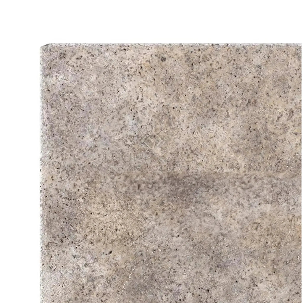 Textured gray stone tile of Silver Travertine 18X18 with unfilled and chiseled edges