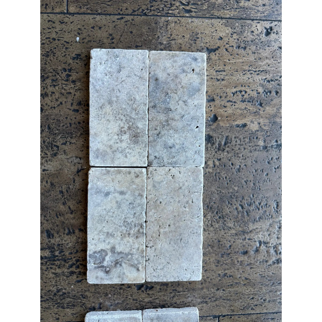 White rectangular Tumbled Travertine 3x6 tiles with a slightly worn texture