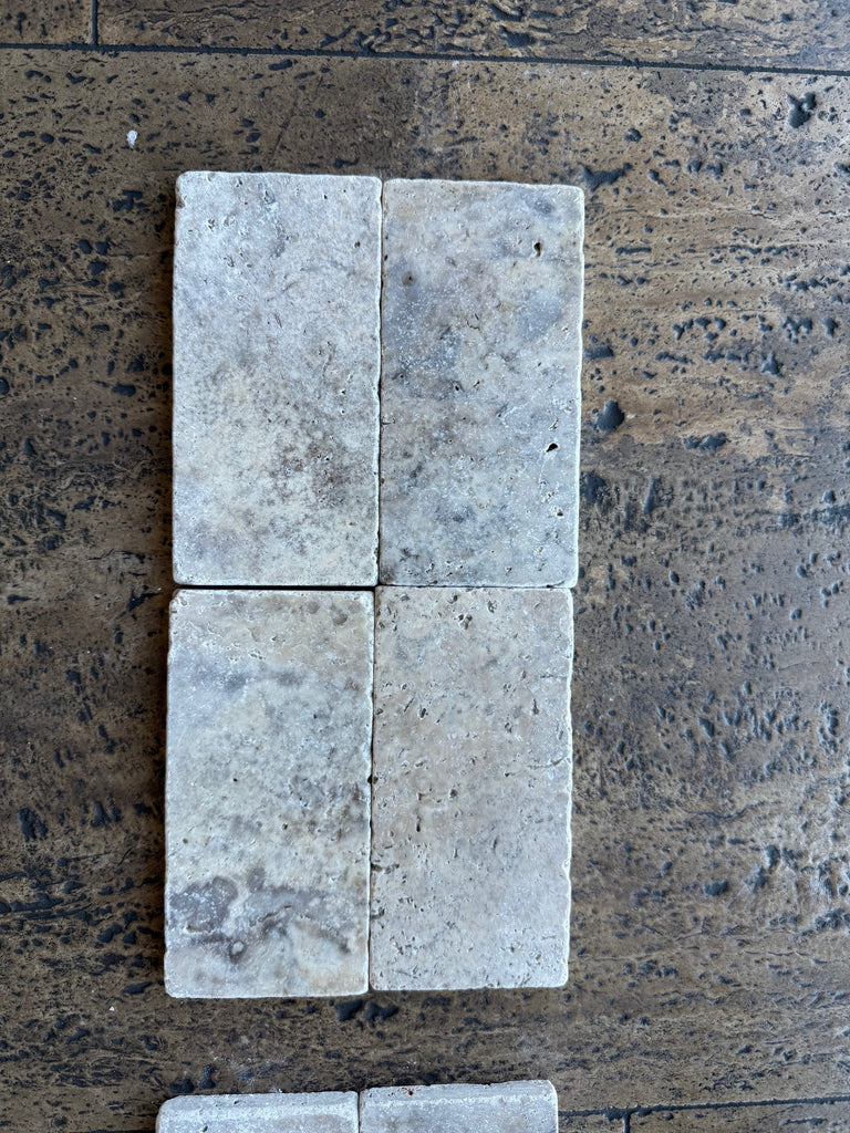 White rectangular Tumbled Travertine 3x6 tiles with a slightly worn texture